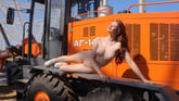 Cute redhead Zoe Foxy undressing by a tractor